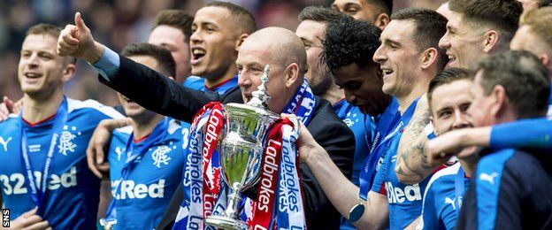 Mark Warburton celebrates Rangers' title win in the Championship