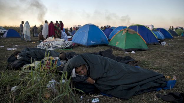 A migrant in a sleeping bag at a makeshift camp in the village of Roszke, Hungary - 7 September 2015