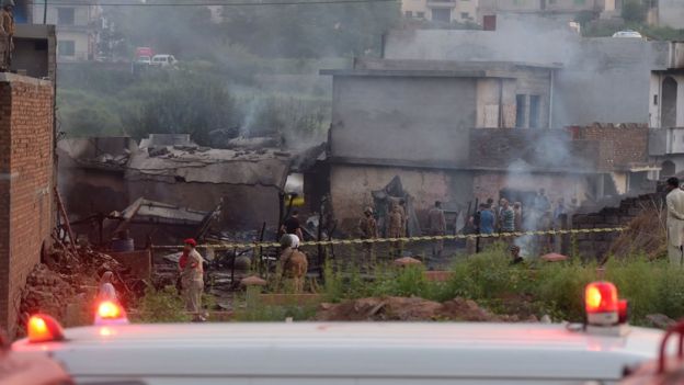 Soldiers and other personnel work at the scene where a Pakistani Army Aviation Corps aircraft crashed in Rawalpindi on July 30, 2019.