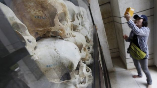 A tourist photographs a collection of skulls of victims who died during the Khmer Rouge regime, on display at the Choeung Ek Genocidal Centre on the outskirts of Phnom Penh on 6 August 2014