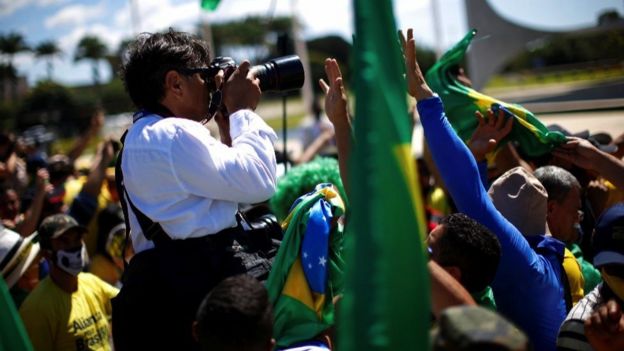 Supporters try to prevent a photographer from working during a rally in Brasilia, 3 May 2020