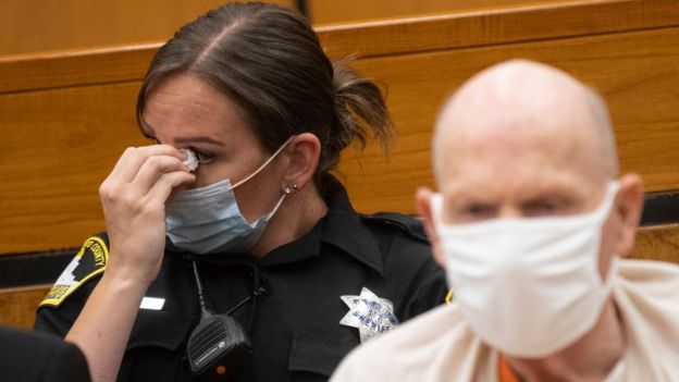 A Sacramento police officer wipes her eyes in court as she listens to victim impact statements