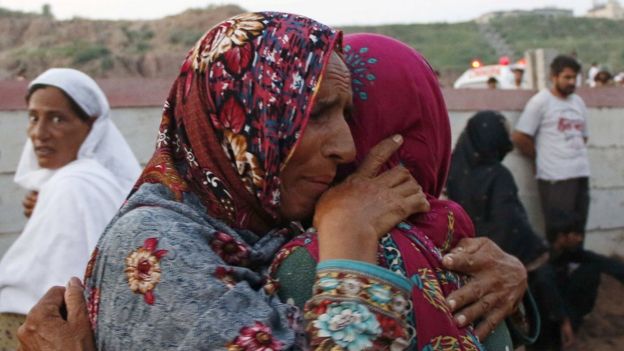 Women mourn the death of their relatives who were killed