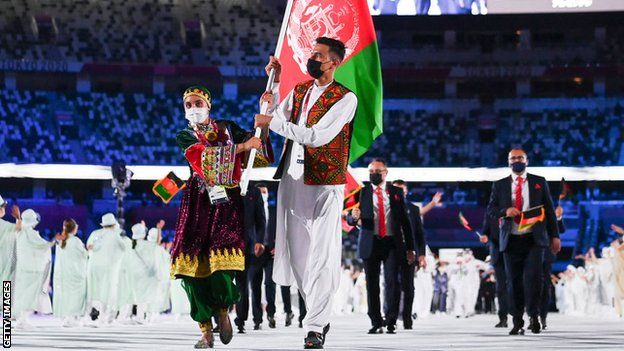 Kimia Yousofi: Afghanistan sprinter and Olympic flag-bearer ...