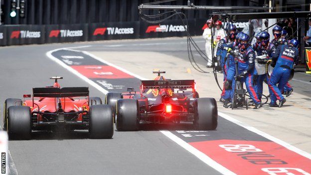 Charles Leclerc and Max Verstappen jostle for position in the pit lane