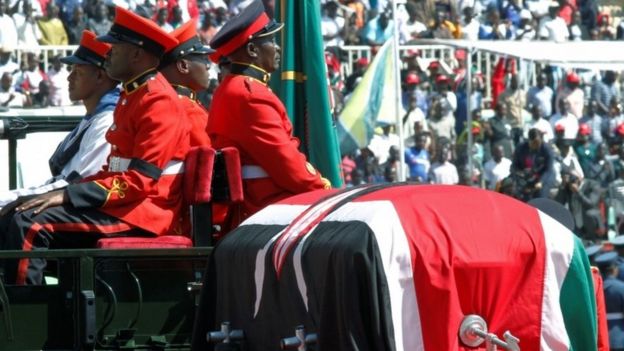 Military officers escort a gun carriage carrying the coffin of Daniel Arap Mo