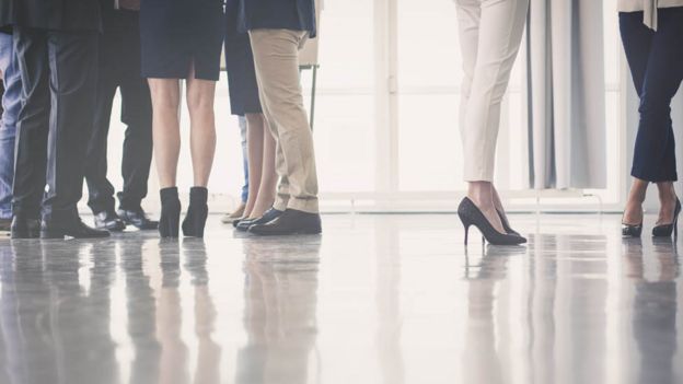 Men and women's shoes in an office