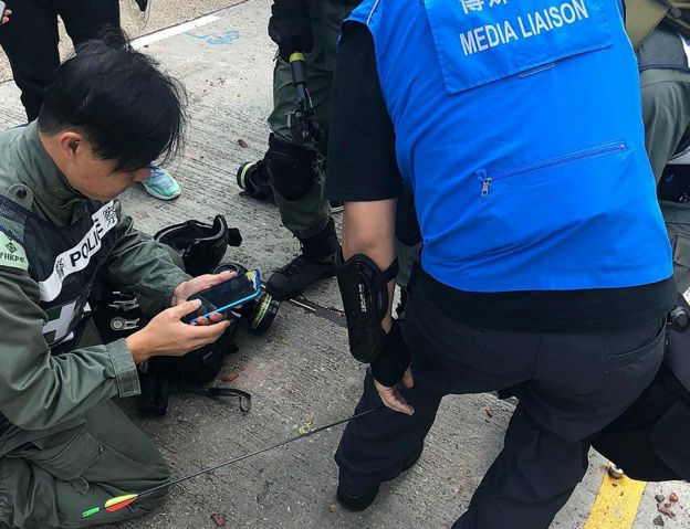 Police media liaison officer hit in the leg by an arrow fired by rioters outside the Polytechnic University of Hong Kong. 17 Nov 2019