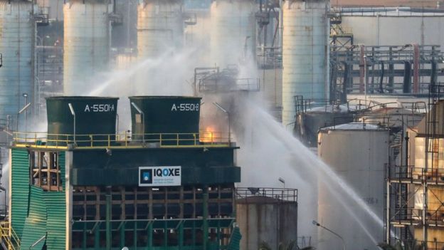 Firefighters spray water after a large fire broke out at the chemical factory in Tarragona, Spain, 15 January 2020