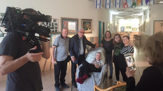 Maxwell Smart (second left) meets Tova (centre) surrounded by her family and documentary crew