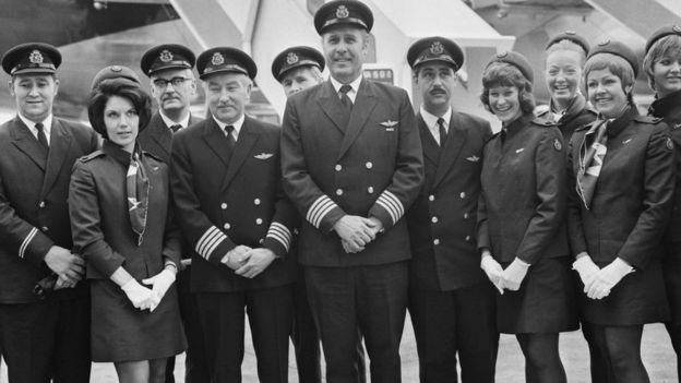 Captain Douglas Redrup of BOAC stands with members of his flight crew before taking off on the first scheduled flight.