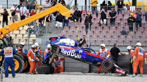 The car of Brendon Hartley is recovered from the track after he crashed during final practice