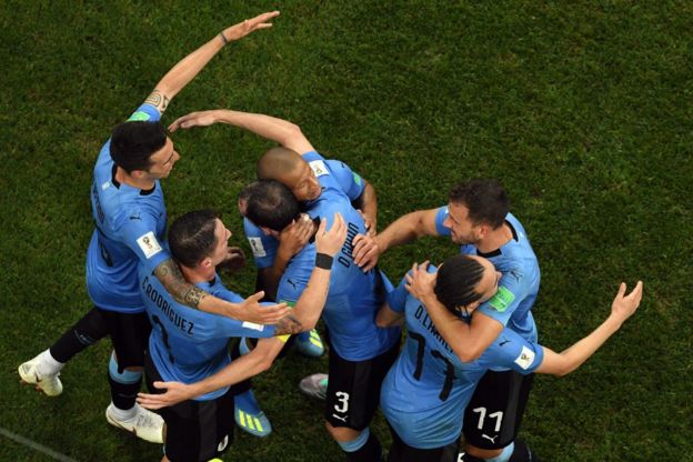 Los jugadores uruguayos se abrazan al final del partido que les dio la clasificación a cuartos de final por segunda vez en los últimos tres mundiales.