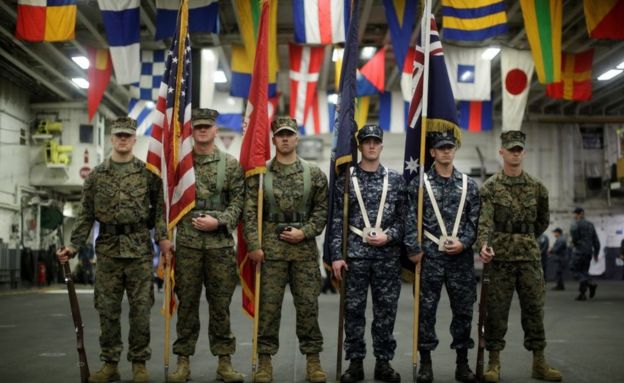 US and Australian navy personnel mark a joint military exercise on board a ship off the coast of Sydney in 2017.