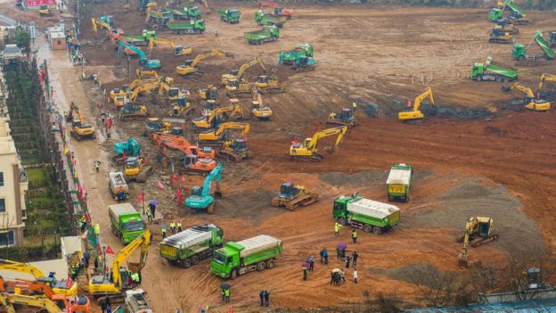 This aerial photo on January 24, 2020 shows excavators and trucks at the construction site of a new hospital being built to treat patients from a deadly virus outbreak in Wuhan in China"s central Hubei province