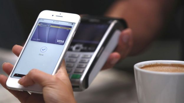 An iPhone being used to pay for a coffee