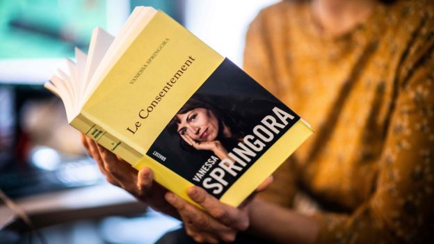 A woman holds the book "Le Consentement" from French writer Vanessa Springora, in Paris on December 31, 2019