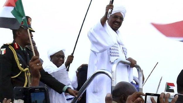 Omar al-Bashir is welcomed by supporters at Khartoum airport