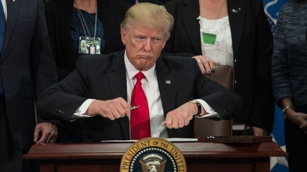 Trump assinando o documento que determina a construção do muro