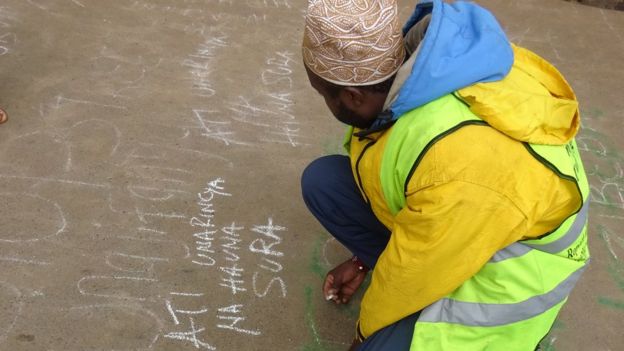 A man writing on the chalkboard