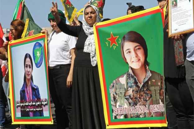 Kurdish protesters wave their national flags and hold photos of Kurdish political leader Hevrin Khalaf (L), who was reportedly killed by Turkish-backed militias, and Sehid Rojinda Qendil, a Kurdish fighter killed in Syria, during a demonstration against the latest Turkish military offensive in north-eastern Syria, in central Beirut's Martyrs Square on October 13, 2019