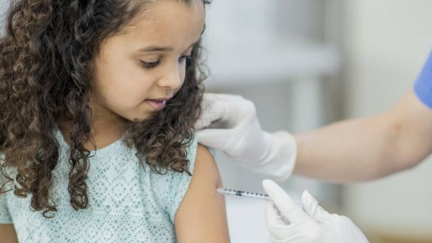 Menina toma vacina