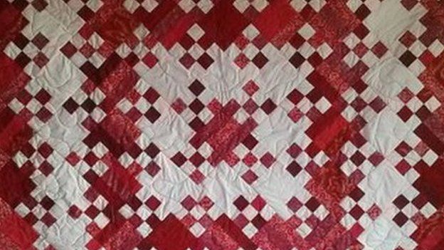 A traditional style quilt made by the artist Eric Suszynski