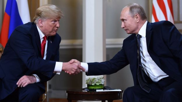 Russian President Vladimir Putin (R) and US President Donald Trump shake hands - 16 July 2018