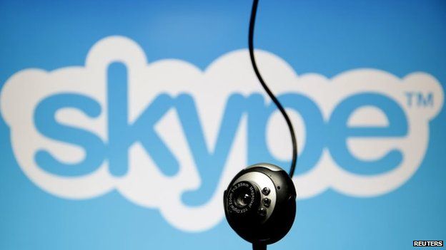 A web camera is seen in front of a Skype logo in this photo illustration taken in Zenica, May 26, 2015