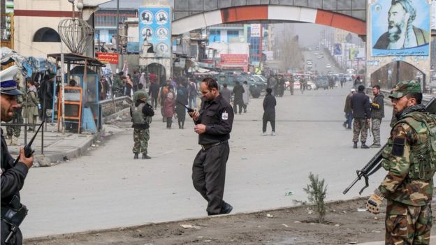 Afghan security forces personnel stand guard on a road near the site of a gun attack that occured during an event ceremony to mark the 25th anniversary of the death of Shiite leader Abdul Ali Mazari, in Kabul on March 6, 2020.