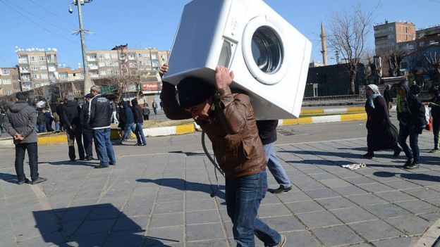 Un hombre carga una lavadora