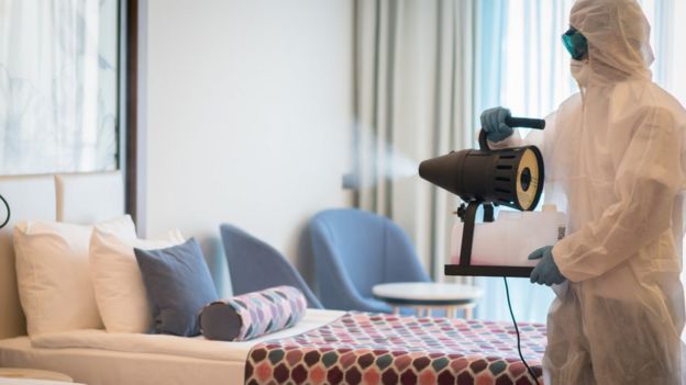 UK hospitality industry calls for 'urgent' support 2 A man in a protective suit disinfecting a hotel room