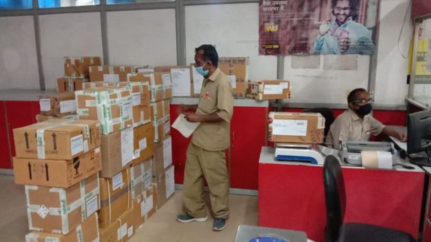 Postal workers sorting medical consignments