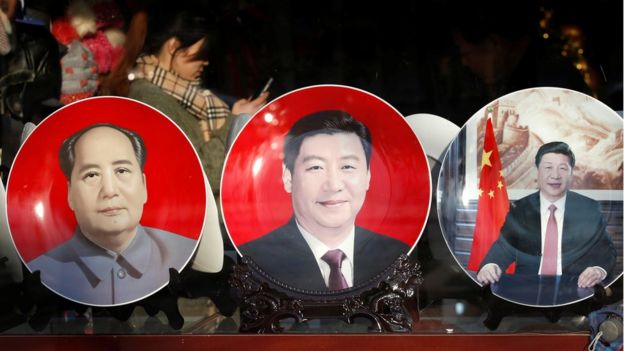 Souvenir plates bearing the images of China's President Xi Jinping and China's late Chairman Mao Zedong (L) are displayed at a shop near the Great Hall of the People where the National People in Beijing, China, 4 March 2015