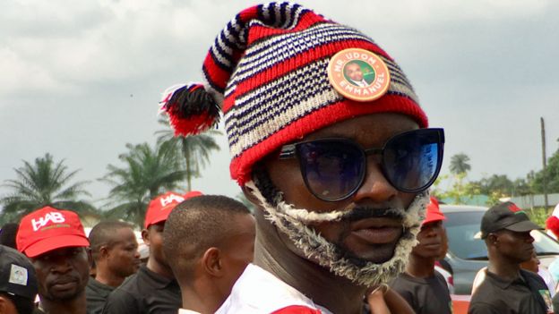 A supporter of PDP governor for Akwa Ibom state Udom Emmanuel wearing a traditional bobble hat