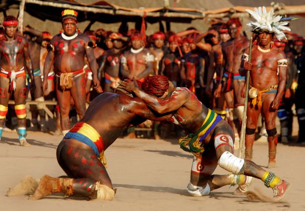 Brazilian Indian warriors of the Yawalapiti (L) and Kuikuro tribes engage in a fight as part of the Kuarup ceremony, in an area of the Amazon forest occupied by the Awara tribe, in central Brazil, 14 August 2005.