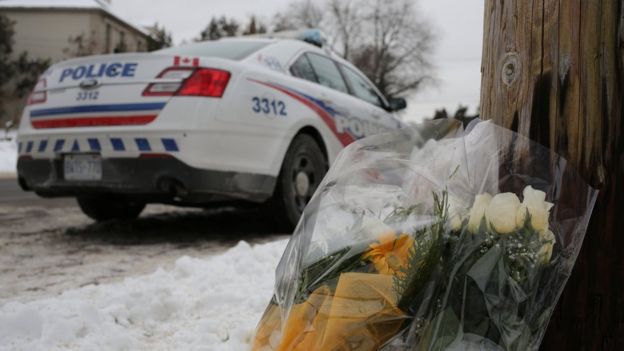 Flowers from mourners are seen outside the home of Barry and Honey Sherman