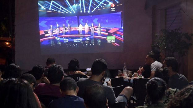 People watch the presidential TV debate in a cafe in Tunis on 7 September, 2019