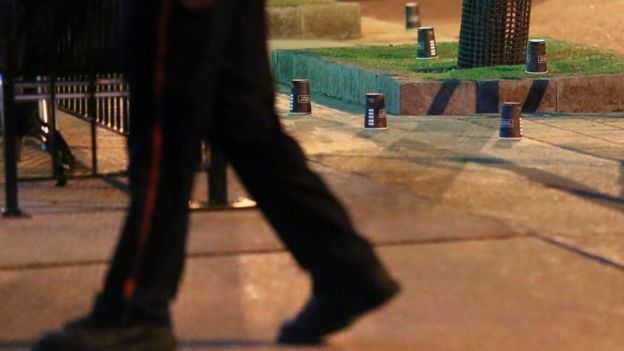 Coffee cups mark evidence at the scene of the attack in Toronto, 23 July