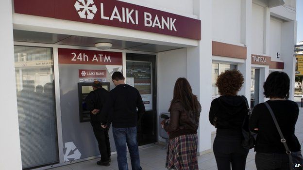 People queue to use a cash machine outside of a Laiki Bank branch in Larnaca, Cyprus, in March 2013