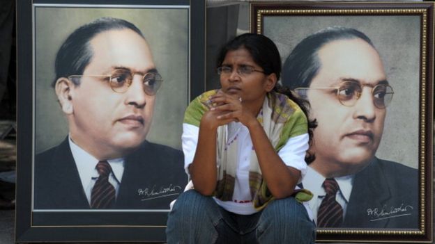 n Indian woman sits infront of portraits of Bhimrao Ramji Ambedkar during 122nd birth anniversary celebrations for Ambedkar in Hyderabad on April 14, 2012.