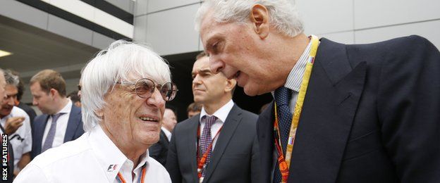Bernie Ecclestone, CEO and President, FOM talks with Marco Tronchetti Provera of Pirelli on the grid.
