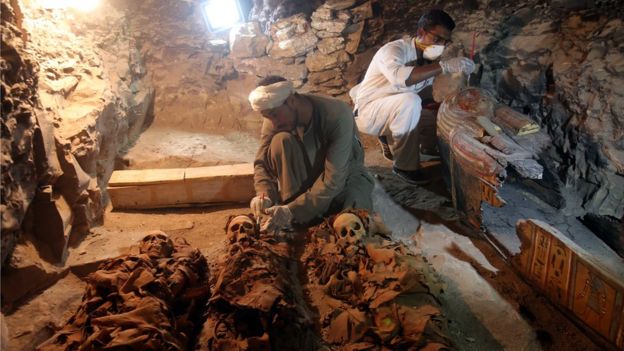 Egyptian archaeologists work on mummies at a recently discovered tomb in the Draa Abul Nagaa necropolis, Luxor's West Bank, 700km south of Cairo, Egypt, 9 September 2017