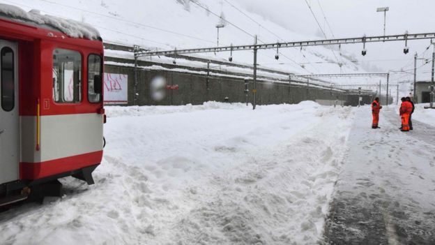 Trains remain blocked by snow on the railway tracks at the Zermatt train station on January 09, 2018.