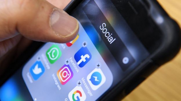 Phone with social media apps on screen