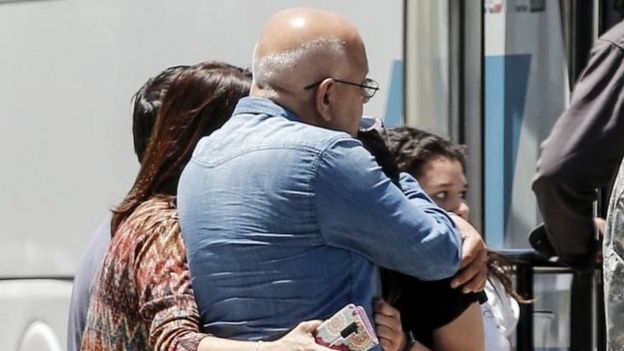 Relatives of people aboard the Chilean Air Force C-130 Hercules cargo plane that went missing in the sea between the southern tip of South America and Antarctica on Monday, embrace at the Cerrillos base in Santiago