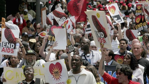 Gente marchando en EE.UU. pidiendo más acciones para acabar con el VIH.