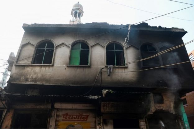 burnt-out mosque and shops are seen following clashes between people supporting and opposing a contentious amendment to India"s citizenship law, in New Delhi on February 26, 2020.