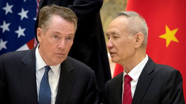 U.S. Trade Representative Robert Lighthizer, left, listens as Chinese Vice Premier Liu He talks while they line up for a group photo at the Diaoyutai State Guesthouse in Beijing, China February 15, 2019.