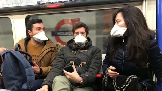 People wearing face masks on the London Underground, as the first case of coronavirus has been confirmed in Wales and two more were identified in England - bringing the total number in the UK to 19